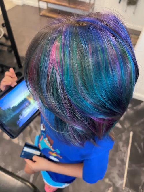 Fashion Hair Color in Commerce City, Colorado This custom oil slick hair color features bold blue, t(..)